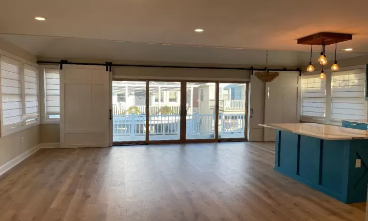 Great room natural light , barn doors leading to front porch