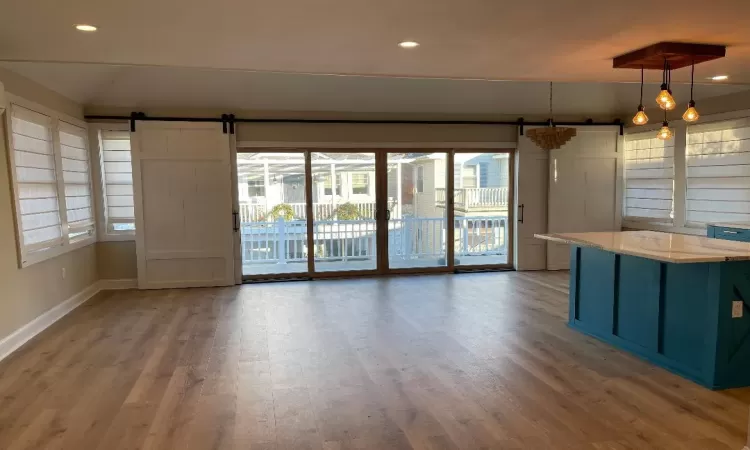 Great room natural light , barn doors leading to front porch