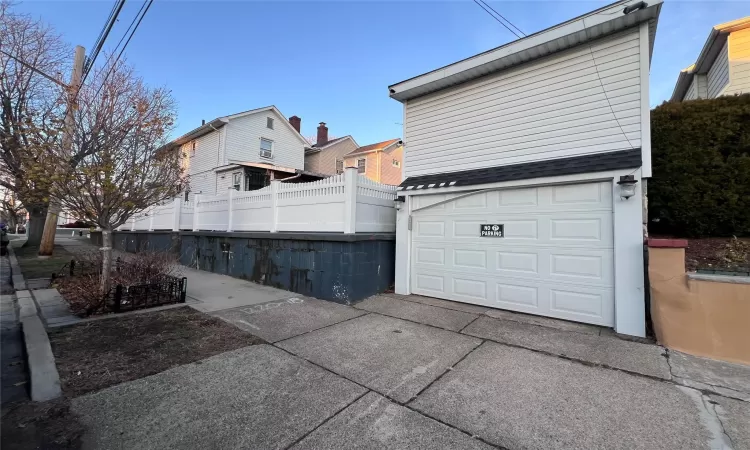 View of side of property with a garage