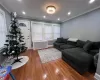 Living room featuring hardwood / wood-style flooring, crown molding, and radiator