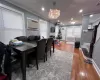 Dining area featuring radiator, crown molding, a wall mounted air conditioner, and light wood-type flooring