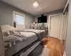 Bedroom with wood-type flooring and a closet