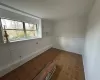 Empty room with parquet floors and a healthy amount of sunlight