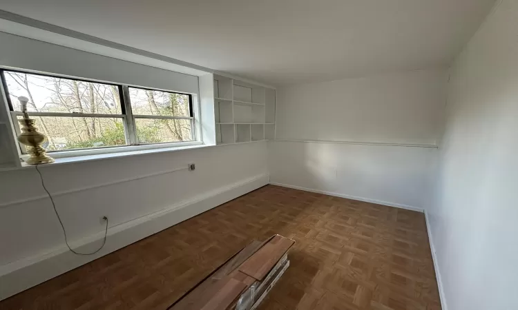 Empty room with parquet floors and a healthy amount of sunlight