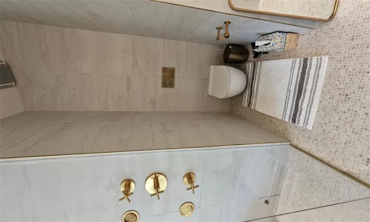 Bathroom with tile walls and vanity