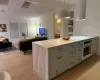 Kitchen with white cooktop, pendant lighting, oven, and light wood-type flooring