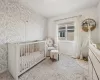 Bedroom with light carpet and a nursery area