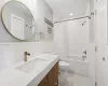 Full bathroom featuring vanity, shower / tub combo, and toilet