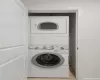 Laundry area with light tile patterned floors and stacked washer and clothes dryer