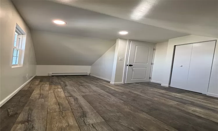 Unfurnished bedroom with dark wood-type flooring and a closet