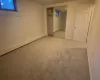 Unfurnished bedroom featuring carpet flooring, a baseboard radiator, and a closet