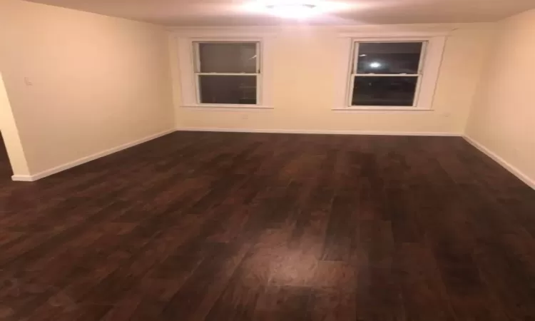 Unfurnished room featuring dark hardwood / wood-style flooring