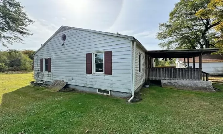 View of home's exterior with a yard