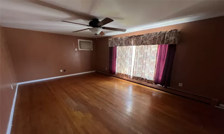 Unfurnished room with hardwood / wood-style floors and ceiling fan