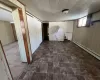 Basement featuring wooden walls and a baseboard heating unit