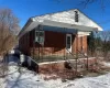 View of snow covered exterior featuring covered porch