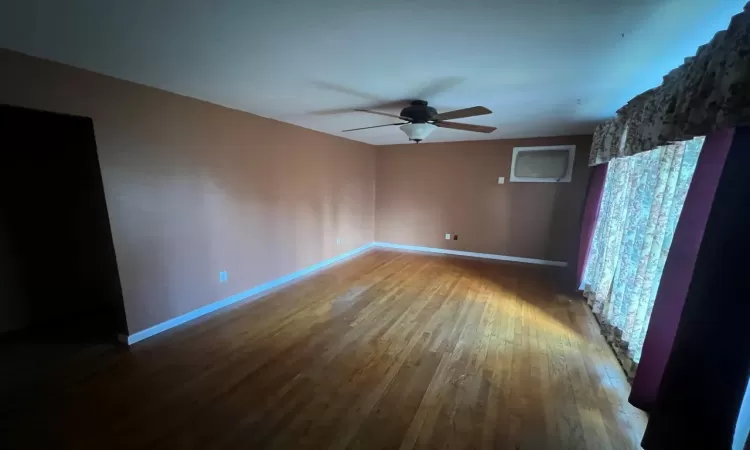 Unfurnished room with hardwood / wood-style floors and ceiling fan