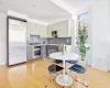 Kitchen featuring decorative backsplash, appliances with stainless steel finishes, light hardwood / wood-style flooring, and gray cabinetry