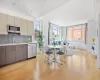 Kitchen featuring appliances with stainless steel finishes, gray cabinets, light hardwood / wood-style flooring, and sink