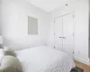 Bedroom with light wood-type flooring and a closet