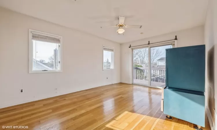 Spare room with wood-type flooring and ceiling fan