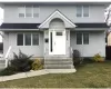 View of front of home with an outbuilding, a front lawn, and a garage