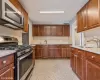 Kitchen featuring decorative backsplash, sink, and stainless steel appliances