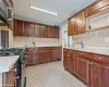 Kitchen with decorative backsplash, stainless steel appliances, and sink