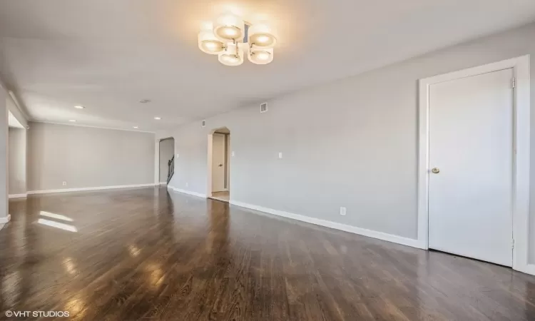 Empty room with dark hardwood / wood-style floors