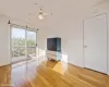 Unfurnished living room with ceiling fan and hardwood / wood-style floors