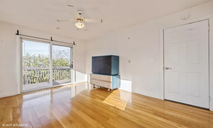 Unfurnished living room with ceiling fan and hardwood / wood-style floors