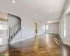 Empty room featuring plenty of natural light and dark wood-type flooring