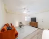 Living room with ceiling fan, radiator, and light hardwood / wood-style flooring