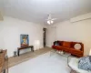 Living room with ceiling fan and light hardwood / wood-style flooring