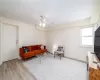 Living room with ceiling fan and light wood-type flooring