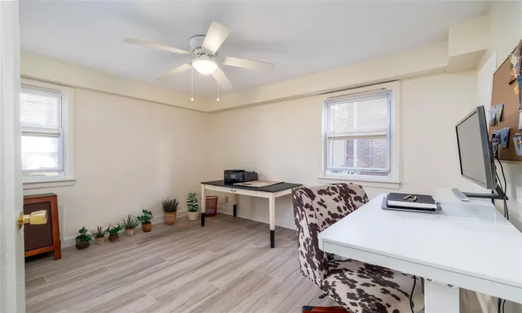 Office area featuring ceiling fan and light wood-type flooring