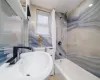 Full bathroom featuring toilet, sink, tile walls, and shower / tub combo with curtain