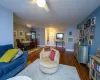 Living room featuring ceiling fan and dark wood-type flooring