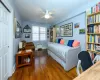 Bedroom with ceiling fan, dark hardwood / wood-style flooring, radiator, and a closet