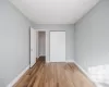 Unfurnished bedroom with hardwood / wood-style floors and a closet