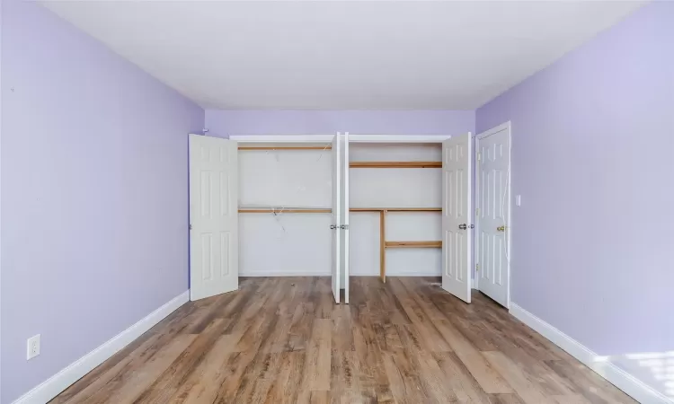 Unfurnished bedroom with hardwood / wood-style flooring