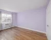 Spare room with a wall mounted air conditioner and light hardwood / wood-style floors