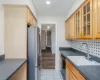 Kitchen featuring tasteful backsplash, sink, light hardwood / wood-style flooring, black dishwasher, and stainless steel refrigerator