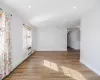 Unfurnished living room with baseboard heating and light hardwood / wood-style floors