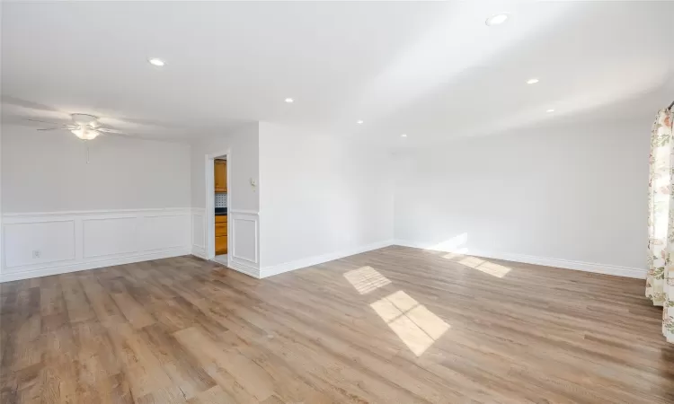 Empty room featuring ceiling fan and light hardwood / wood-style flooring