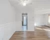 Spare room featuring baseboard heating, ceiling fan, and light hardwood / wood-style floors