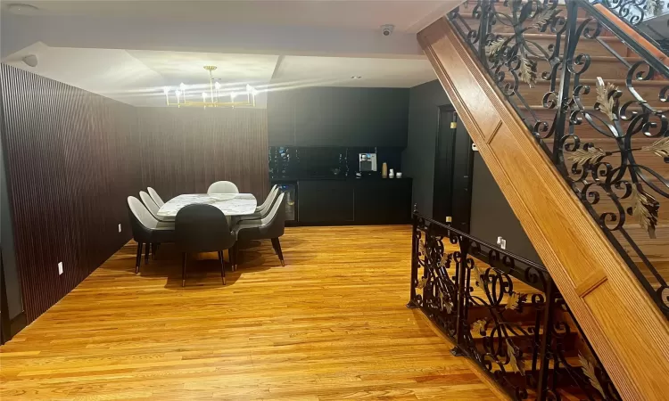 Dining room with a notable chandelier and light hardwood / wood-style floors