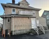 Back house at dusk with central air condition unit