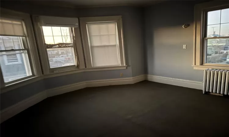 Unfurnished room with radiator