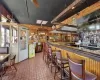 Bar featuring wood walls and ceiling fan